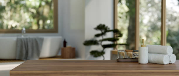 istock Wood tabletop with empty space over blurred modern bathroom with bathtub in background 1470633950
