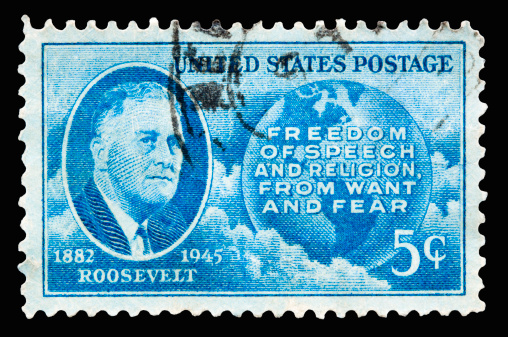A 1945 issued 5 cent United States postage stamp showing President Roosevelt - Freedom of Speech and Religion from Want and Fear.