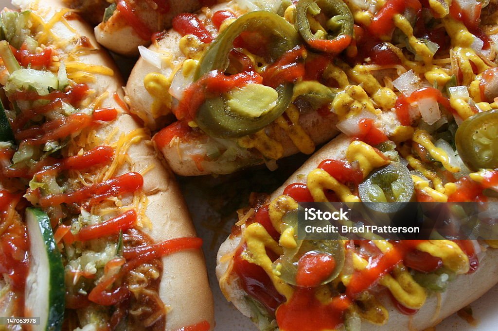 Fully loaded & very colorful chili dogs Three chili dogs fully loaded with lots of toppings Hot Dog Stock Photo