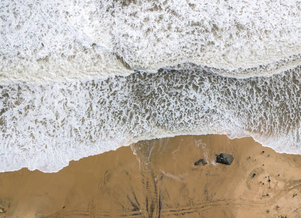 istock Waves crashing on the sandy shore on a stormy day 1470643056