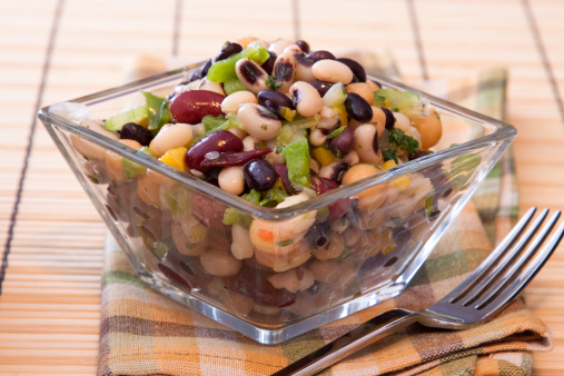 Healthy salad made with red kidney beans, black eyed peas, corn, spring onions, chickpeas, celery, and seasoning.