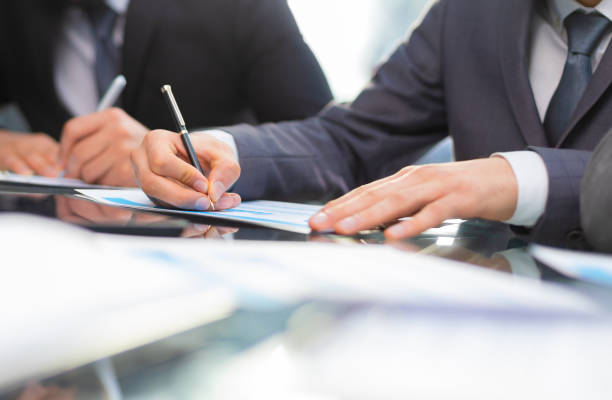 istock Business professionals working together at office desk, analyzing financial statistics displayed on the laptop screen. 1470645094