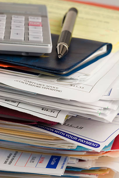 istock Pen, Calculator and Check Book on a Stack of Bills 147064838