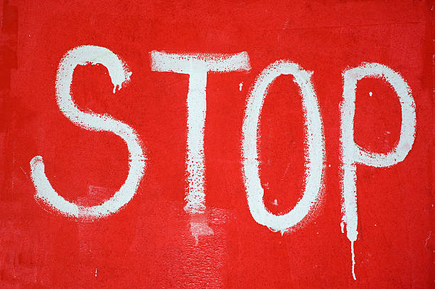 Stop sign painted on wall stock photo