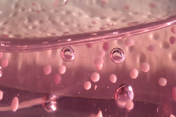 Pink background with air bubbles and granules for spa treatments
