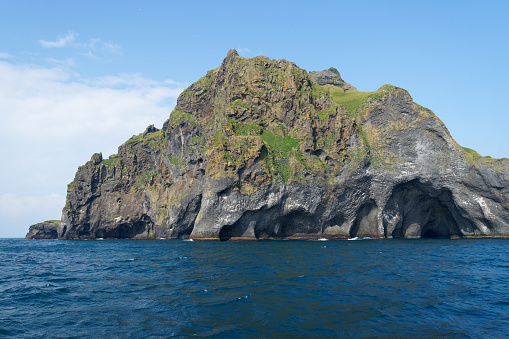 rocky cliffs on Heimaey Island off the southern coast of Iceland