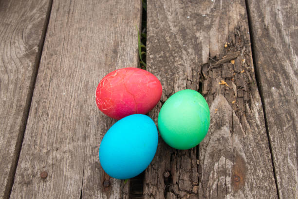 istock multi-colored easter eggs lie on an old wooden board, on quarantine on Easter day 1470653995