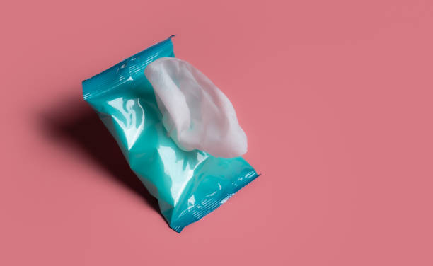 istock Open wet wipes flow pack on pink background,flat lay. Space for text 1470654744