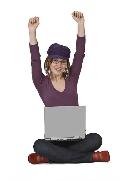 Happy young woman sitting with a laptop in her lap.