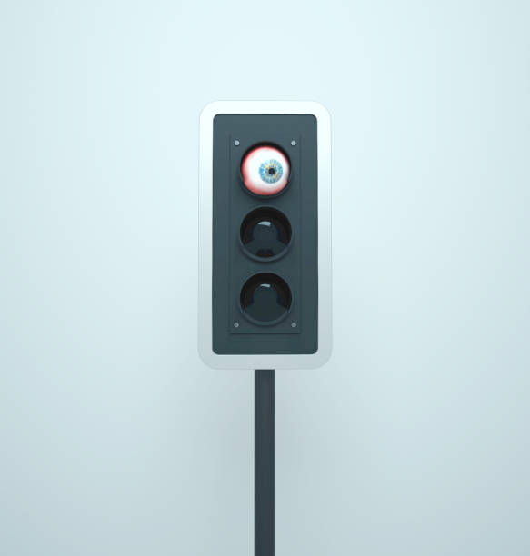 istock Traffic light looks around with human eye. Protection surreal concept. 1470655516
