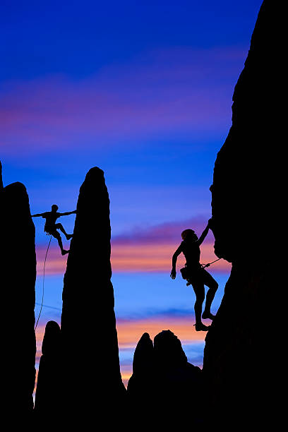 istock Team of rock climbers reaching the summit. 147065667