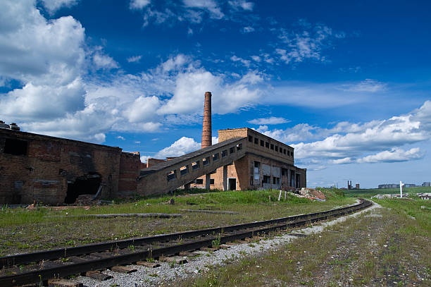 istock Old mine ruins near rusty rails under the wonderful sky 147065728