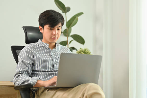 istock Successful young businessman using laptop, working on marketing project at modern office interior. 1470658827