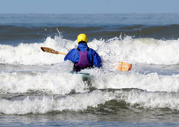 kayaker facing the waves stock photo