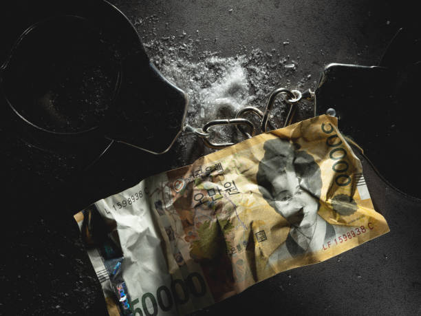 Handcuffs, Korean banknotes and drug powder stock photo