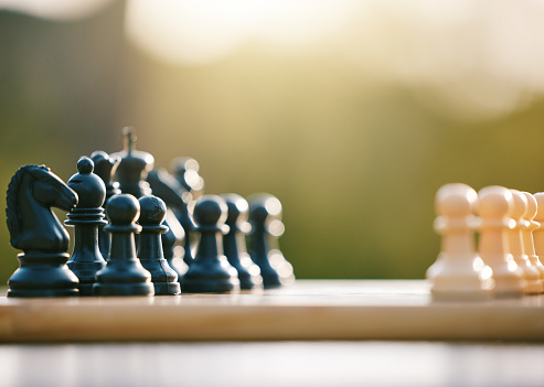 Game, smart and chess sport in nature for a challenge, strategy and brain competition in Ireland. Battle, match and board for games, strategic fun and tactics in a park or field for logic play