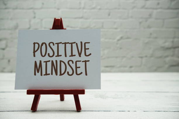 istock Positive Mindset text on white brick wall and wooden background 1470660891