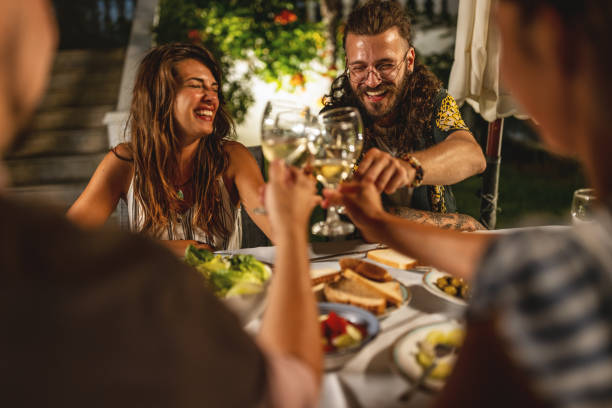 istock Happy friends toasting at summer dinner 1470662760