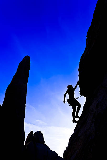 istock Rock climber clinging to a cliff. 147066412