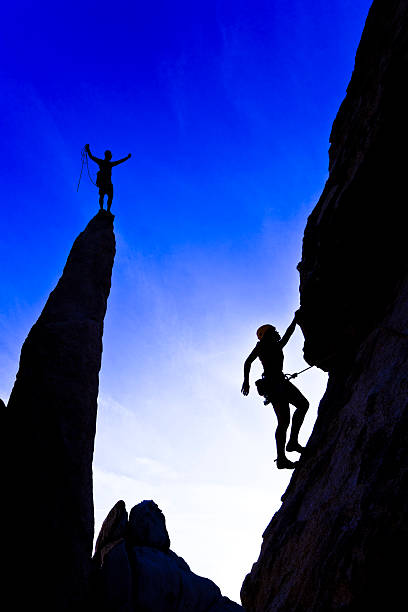 istock Team of rock climbers reaching the summit. 147066419