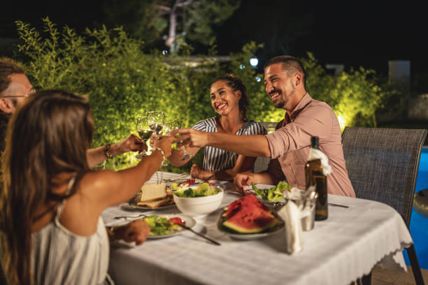 istock Happy friends toasting at summer dinner 1470664519