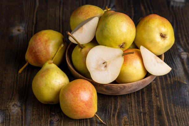 istock A yellow ripe pear with a red side on the table 1470665306