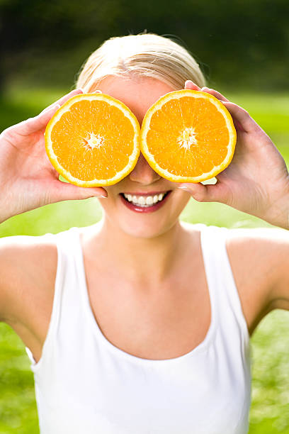 istock Woman holding oranges over eyes 147066537