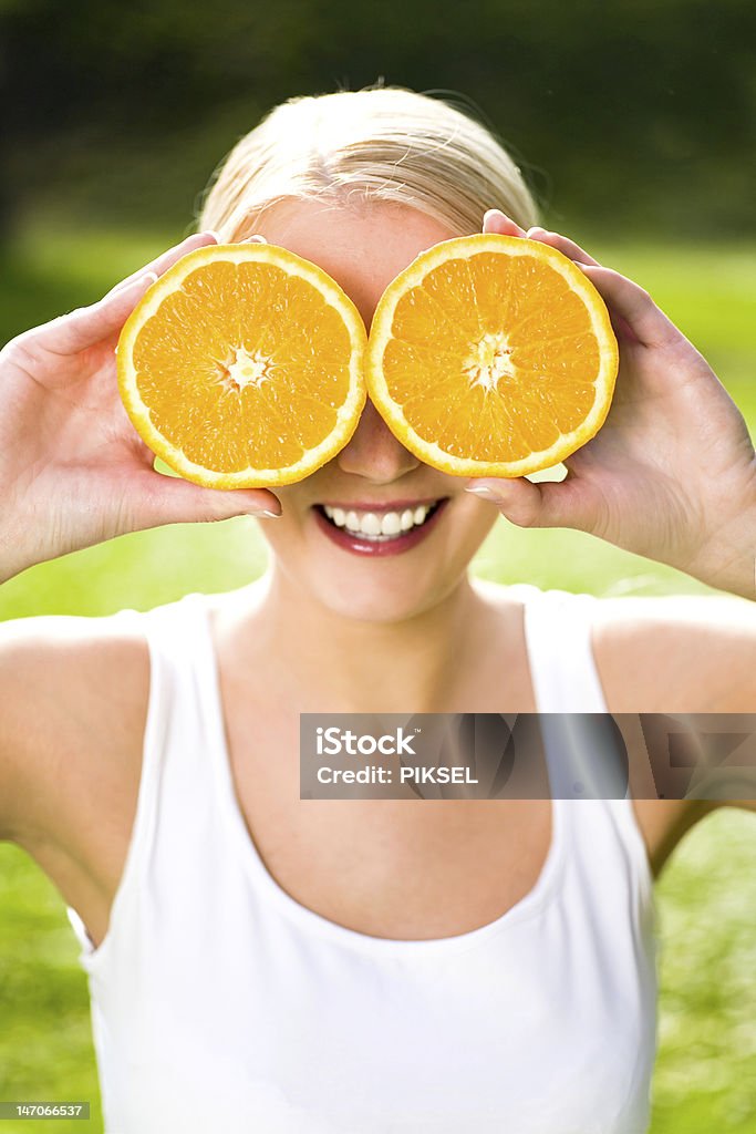 Woman holding oranges over eyes http://www.edkafelek.com/peopleoutdoors.jpg Adult Stock Photo