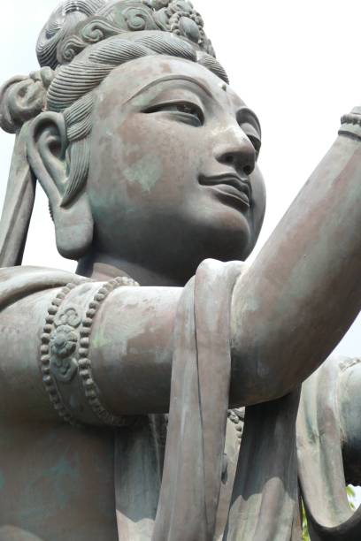 istock Vertical closeup shot of a Buddha statue on a bright sky background 1470669181