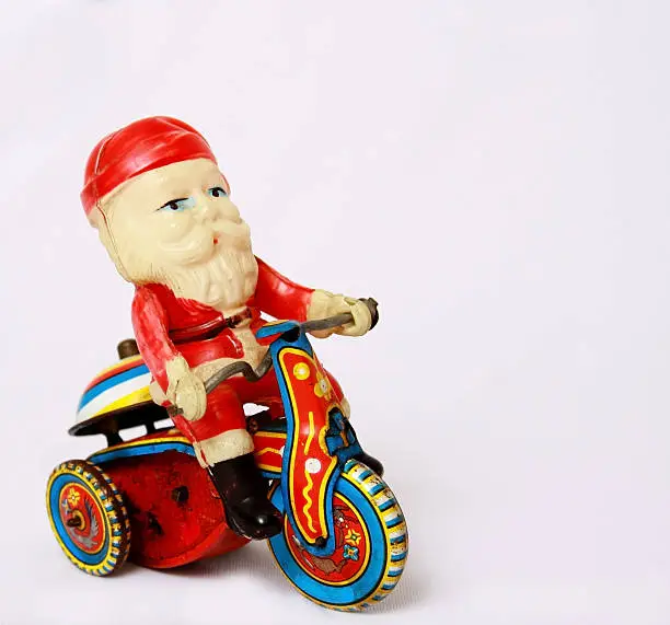 Photo of Vintage Santa Toy on Tin Motorcycle
