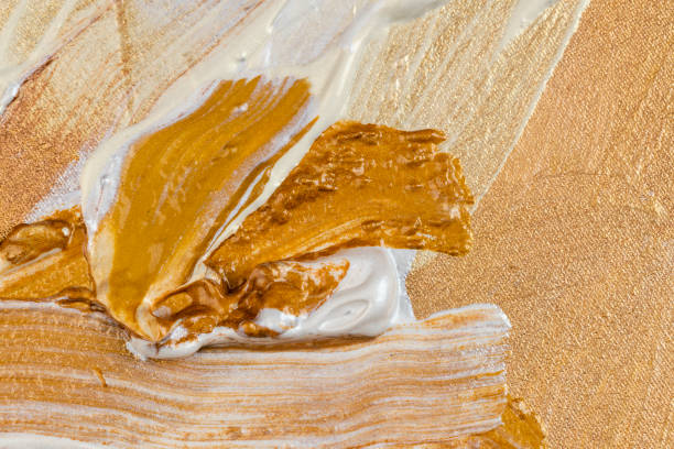abstract background painted on linen canvas with yellow and gold acrylic paints, background of gilded paints
