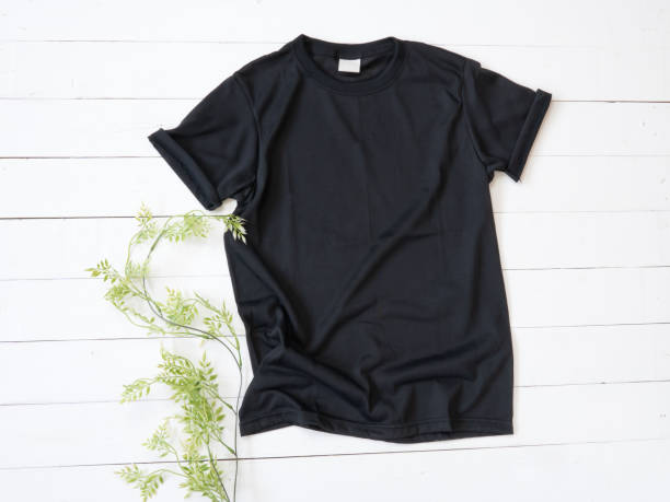 istock Black T Shirt mockup on white wood background 1470674505