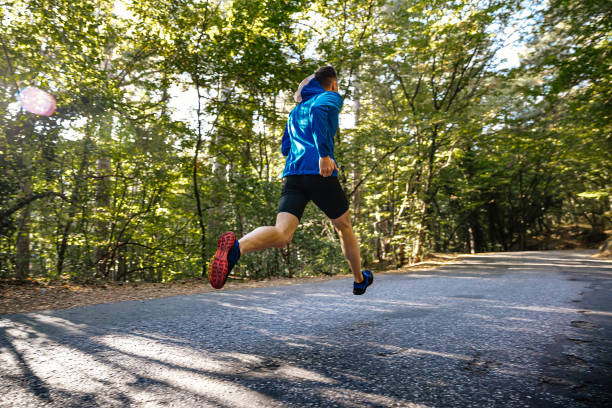 istock male runner running on road in park 1470674537