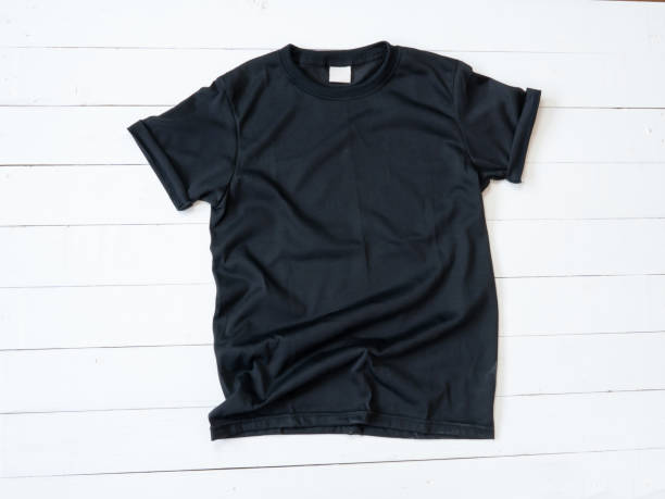 istock Black T Shirt mockup on white wood background 1470674601