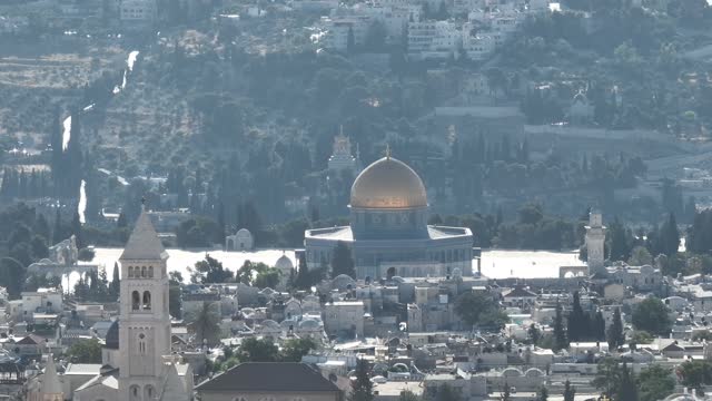 Aerial view of mosques churches with the Dome of the Rock revealing behind Jerusalem