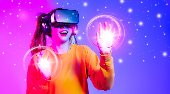 Metaverse technology. Asian woman wear vr goggles headset touching, looking, connecting digital virtual reality world like gaming and entertainment.