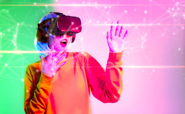 istock Metaverse technology concept. Asian girl wearing vr goggles headset watching playing connecting to digital virtual world green pink color background. 1470681901
