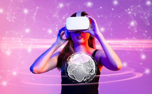 Metaverse technology. Woman wear vr goggles headset watching, playing, connecting online virtual reality space world purple background.