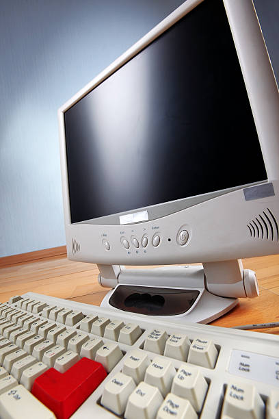 istock classic work place - keyboard and monitor at table 147068291