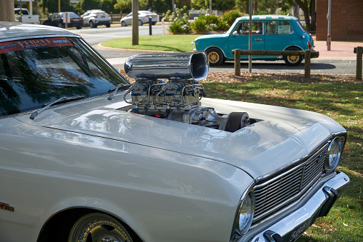 A White Ford Fairmont with Supercharged Engine at Tongala Show and Shine Victoria Australia, this vehicle is set-up for drag racing with a parachute