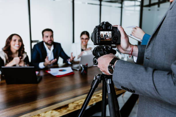 istock Hispanic Teamwork recording a video talk for social media with professional camera at the office in Mexico Latin America 1470683441