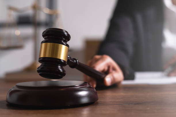 istock Hand of judge using judge hammer on work desk. 1470683841