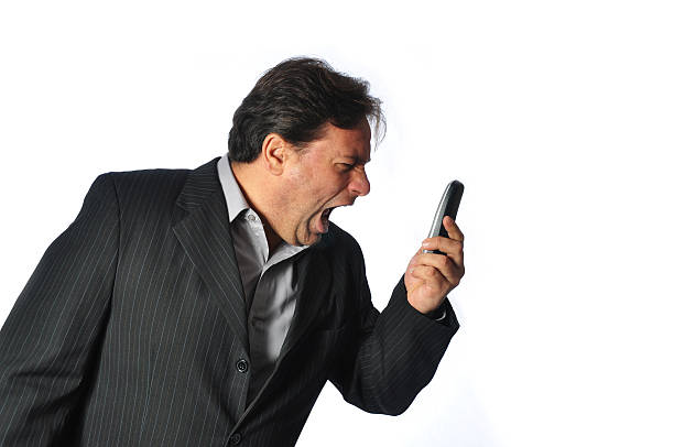 Studio Shot of Business Man shouting in his Phone. stock photo