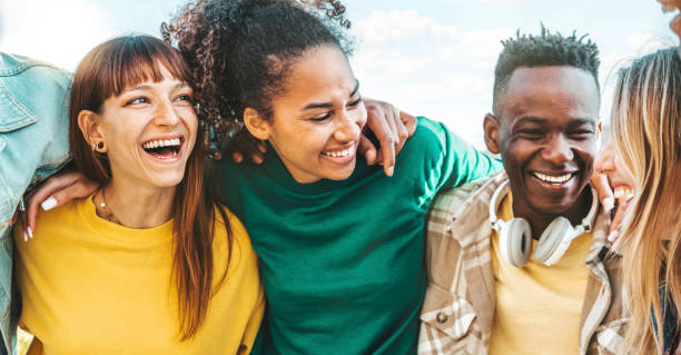 istock Happy multicultural enjoying summer vacation outdoors - Smiling group of friends having fun walking outside - Friendship concept with guys and girls hanging out on a sunny day 1470686818