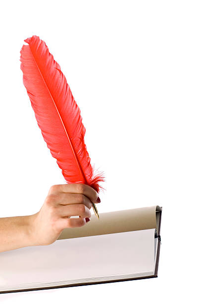 hand with quill stock photo