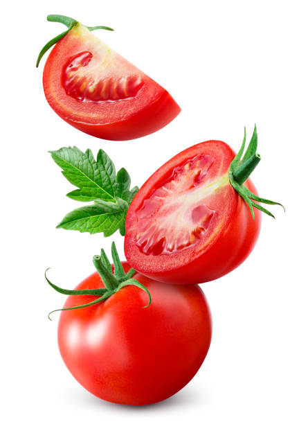 istock Tomato isolated. Whole tomato with leaf flying on white background. Falling tomato, half, slice and leaves side view composition. Full depth of field. 1470688129