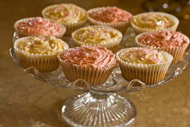 Cupcakes on antique glass cake stand stock photo