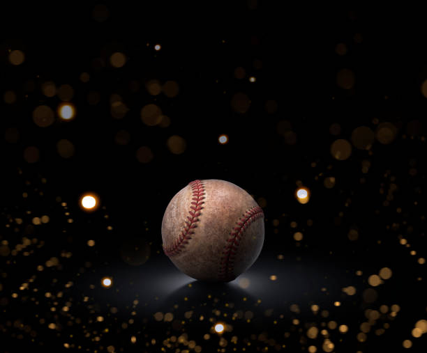 istock single baseball ball on black background with abstract lights 1470689432