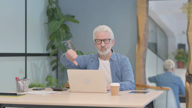istock Thumbs Up by Old Man Working on Laptop 1470690326