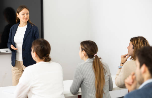 istock Knowledgeable female professor explaining subject to classroom full of students 1470691207